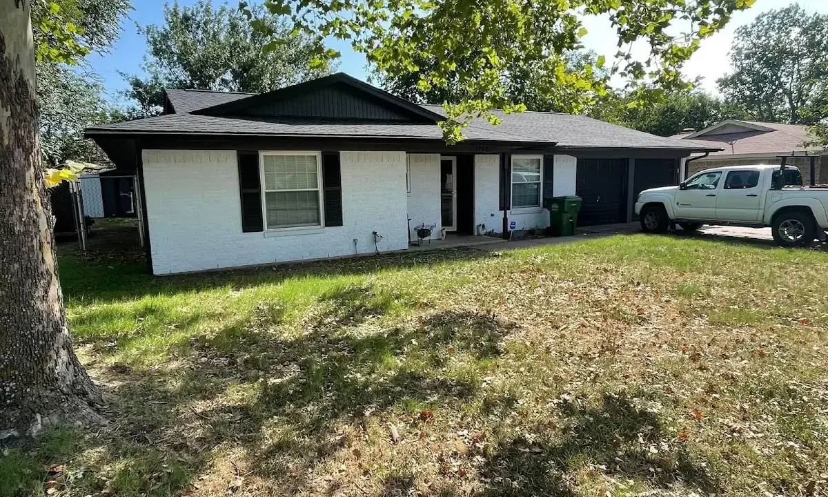 Professional roofing crew working on a residential roof in West Perrine